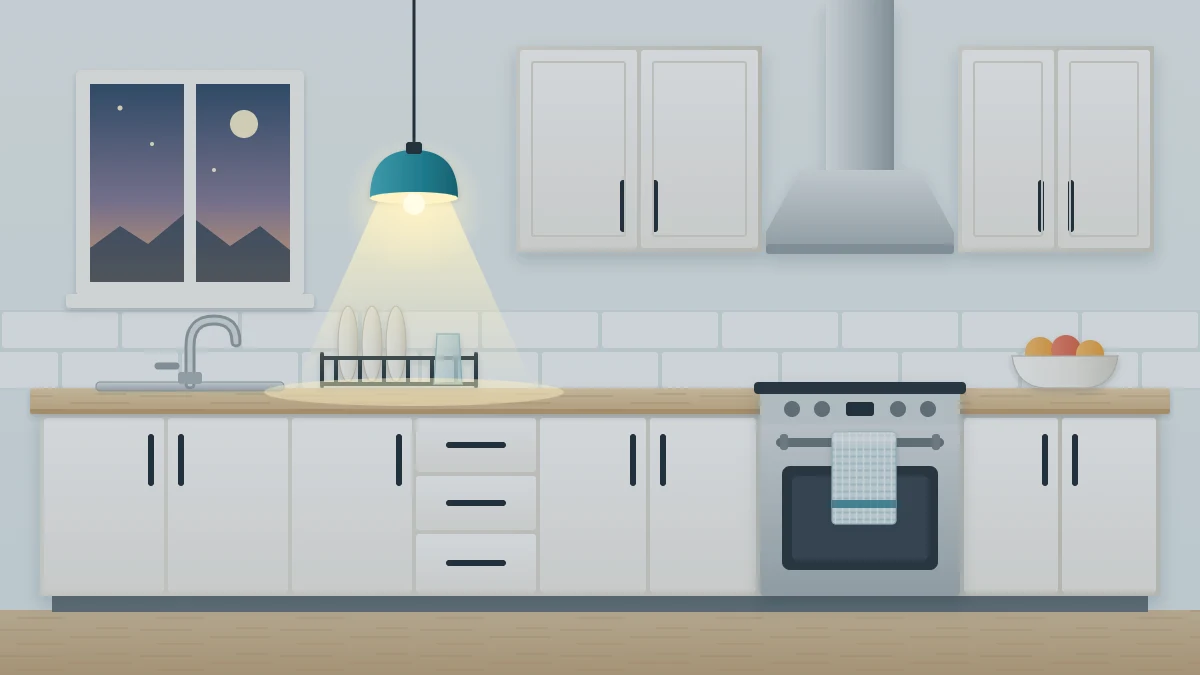 Evening kitchen with a clear countertop, a dish rack with a few plates by the sink, a folded towel on the oven handle and a glowing pendant lamp